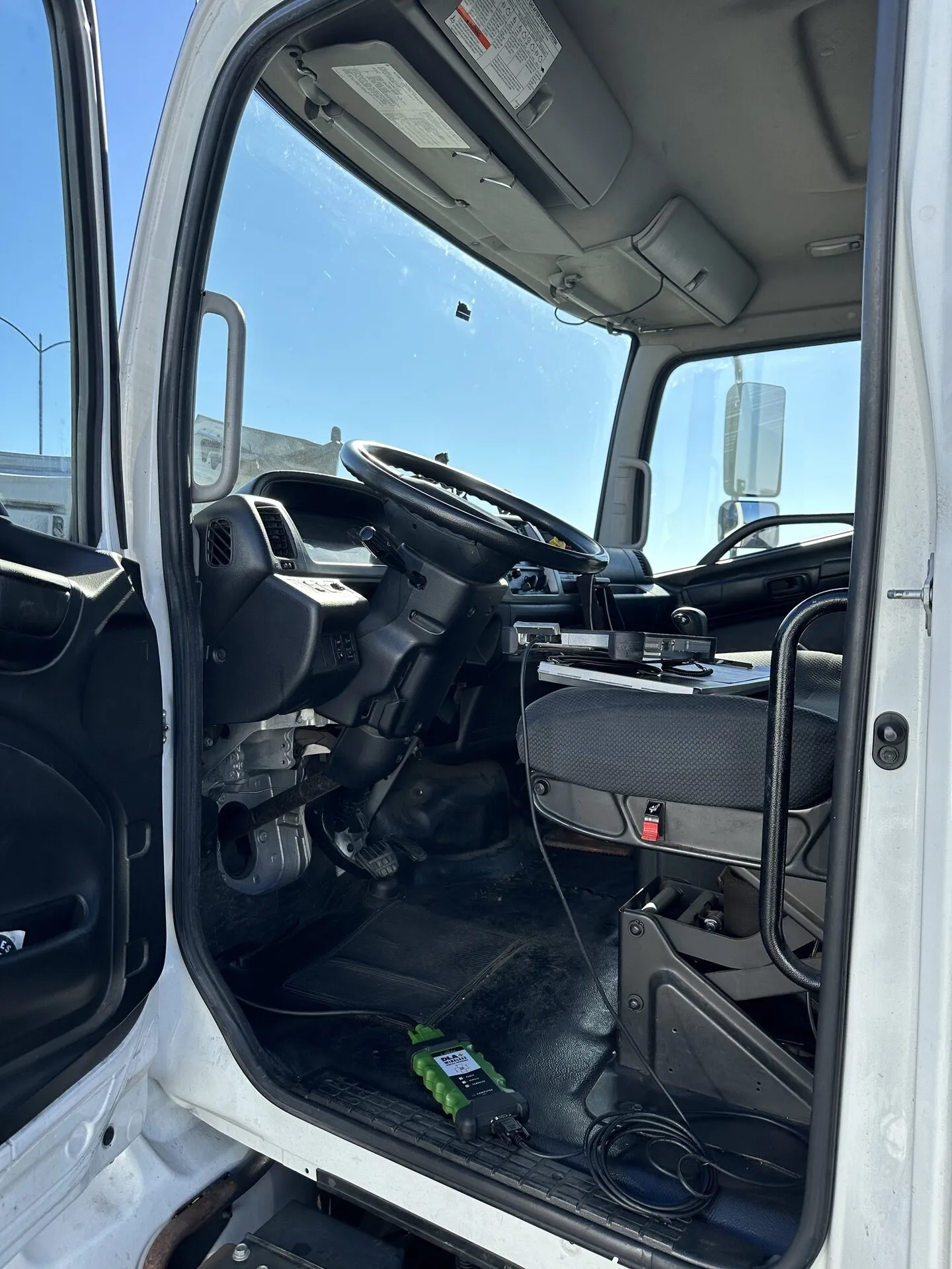 OBD-II scanner connected to a heavy-duty truck during a mobile CARB Clean Truck Check
