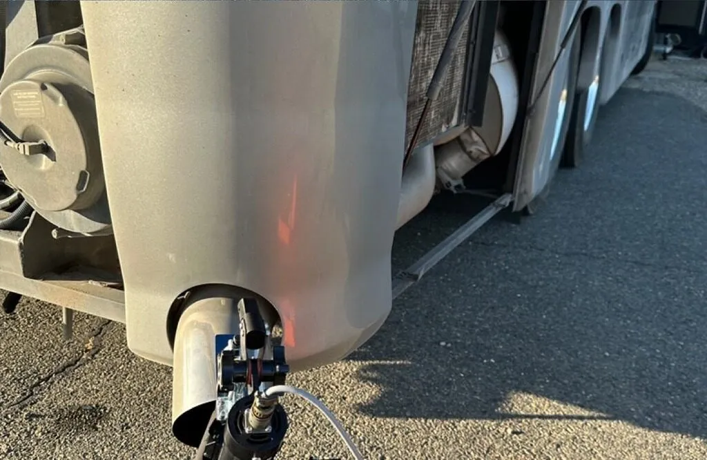 Close-up of opacity test probe inserted into a diesel truck exhaust stack during an OVI inspection