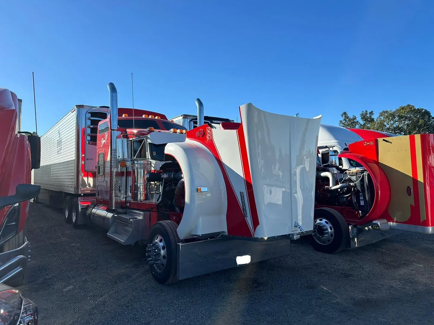 Red Peterbilt Class 8 semi-truck with hood raised during a CARB Clean Truck Check inspection in a Sacramento fleet yard