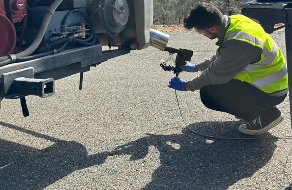 CARB credentialed technician performing a mobile CARB Clean Truck Check test on a heavy-duty diesel truck